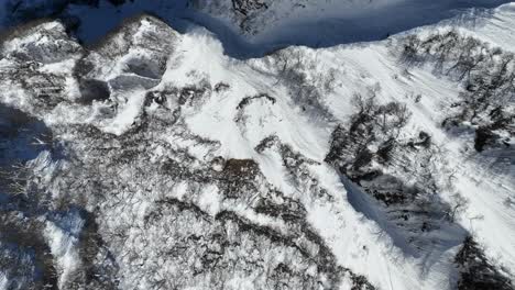 Tracking-top-down-shot-of-Japan's-mount-myōkō-valley,-height-of-mountains-revealed