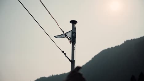 Person On A Boat Pointing His Finger To The Mountain On A Sunset