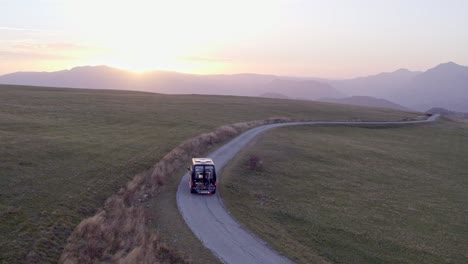 Drone-following-motorhome-on-small-local-road-at-Durmitor-National-Park-Montenegro,-aerial