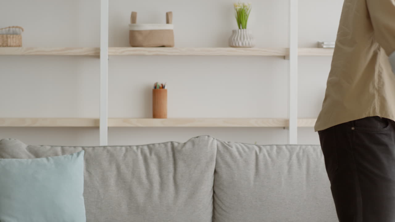 Person using a crutch in a living room