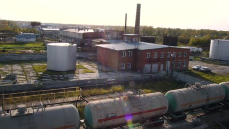 industrial area with storage tanks and tanker trucks