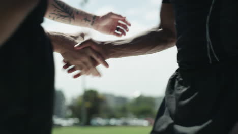 a group of rugby players shaking hands during