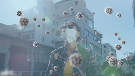 animation of covid 19 virus cells over woman wearing face mask using smartphone