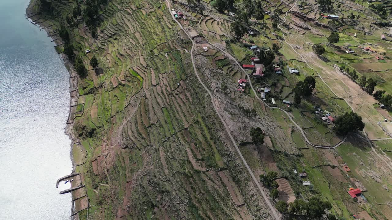 Flyover dramatic green terraced hillsides on Taquile Island in Peru