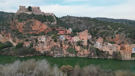picturesque view of miravet town nestled on a hill by the river in tarragona spain