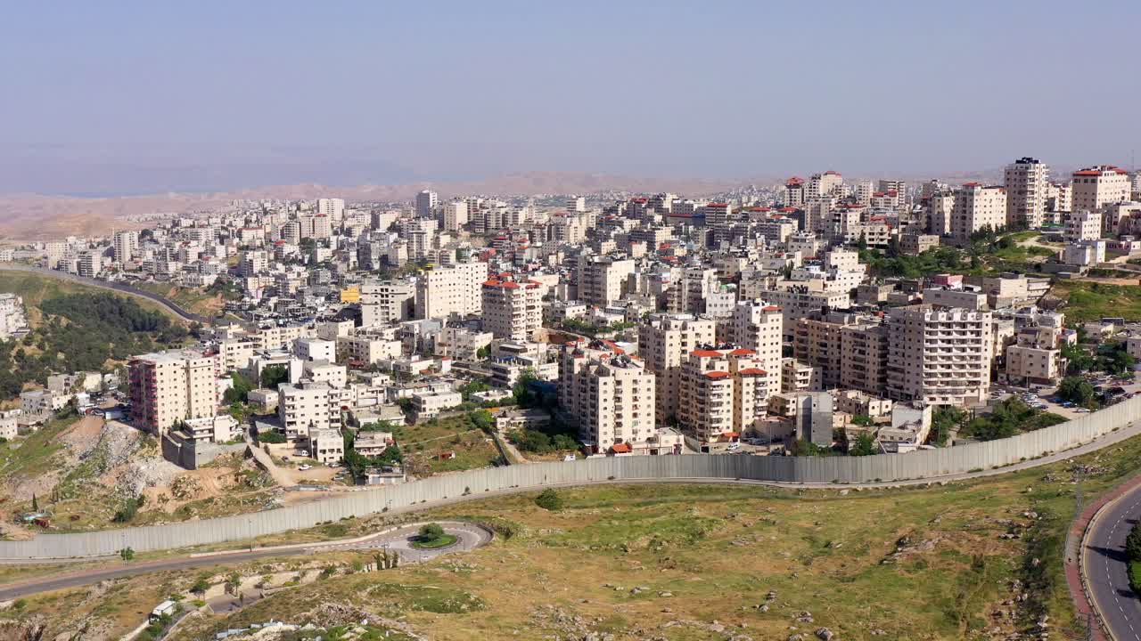 Aerial View of a Densely Populated City with a Security Barrier