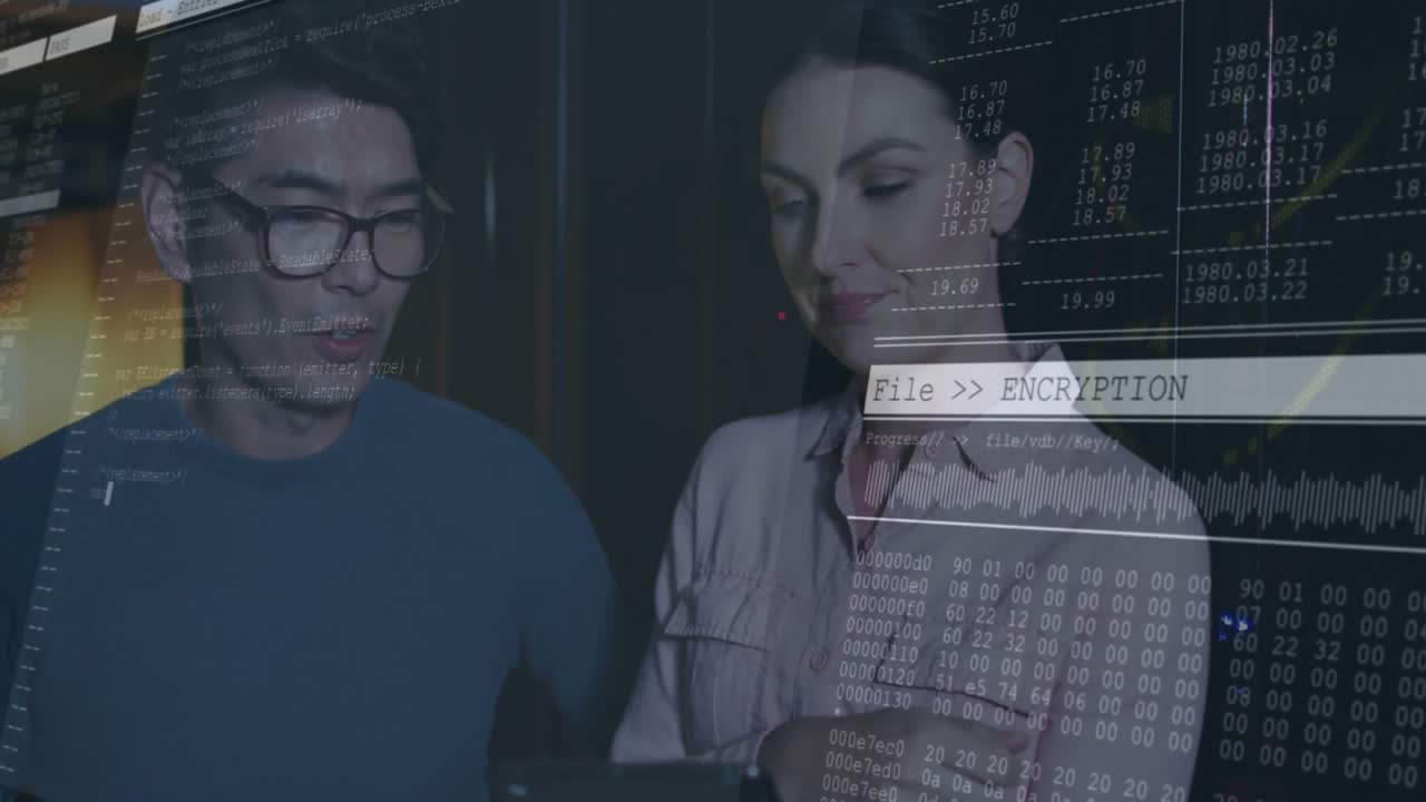 Woman tapping tablet and starting encryption overlay securing data while man monitoring progress