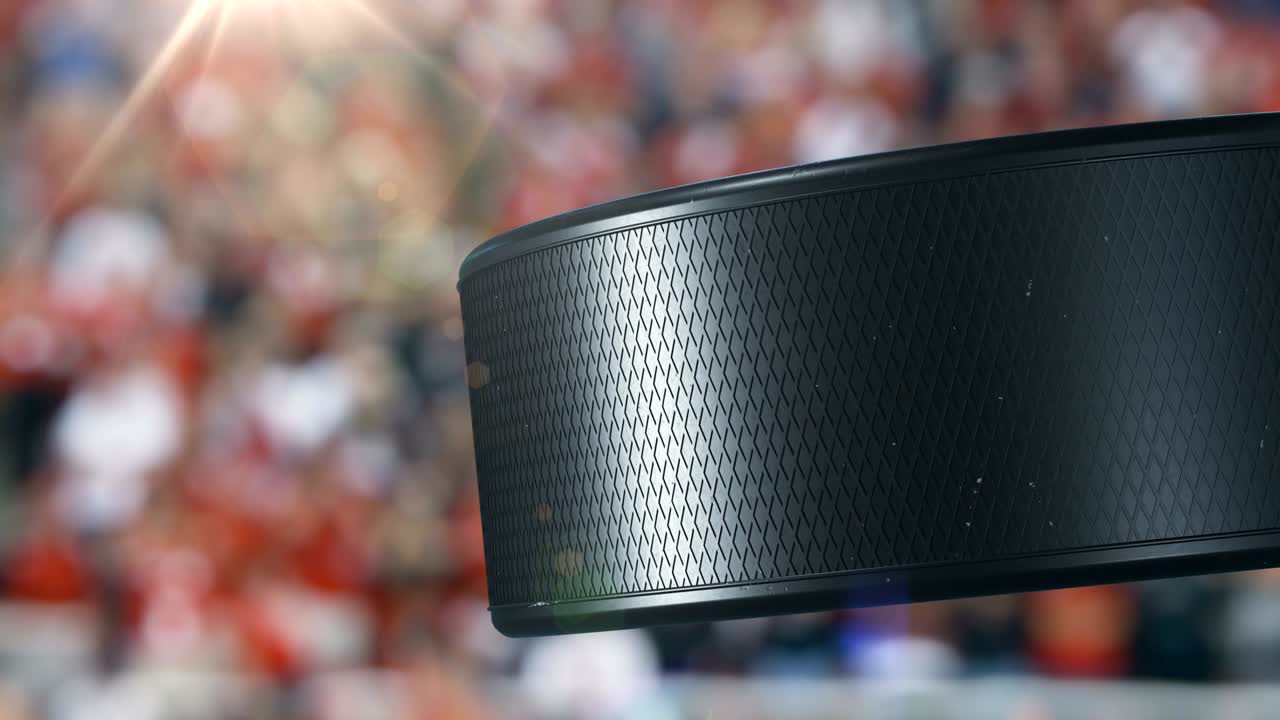 Beautiful Hockey Puck Rotating Close-up at Stadium Tribunes in Slow Motion. Looped Hockey 3d Animation of Turning Puck Isolated. Sport Concept.