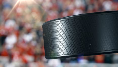 beautiful hockey puck rotating close-up at stadium tribunes in slow motion. looped hockey 3d animation of turning puck isolated. sport concept.