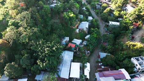 Aerial-view-of-a-rural-village-with-homes-surrounded-by-lush-greenery,-showcasing-a-community-nestled-in-nature