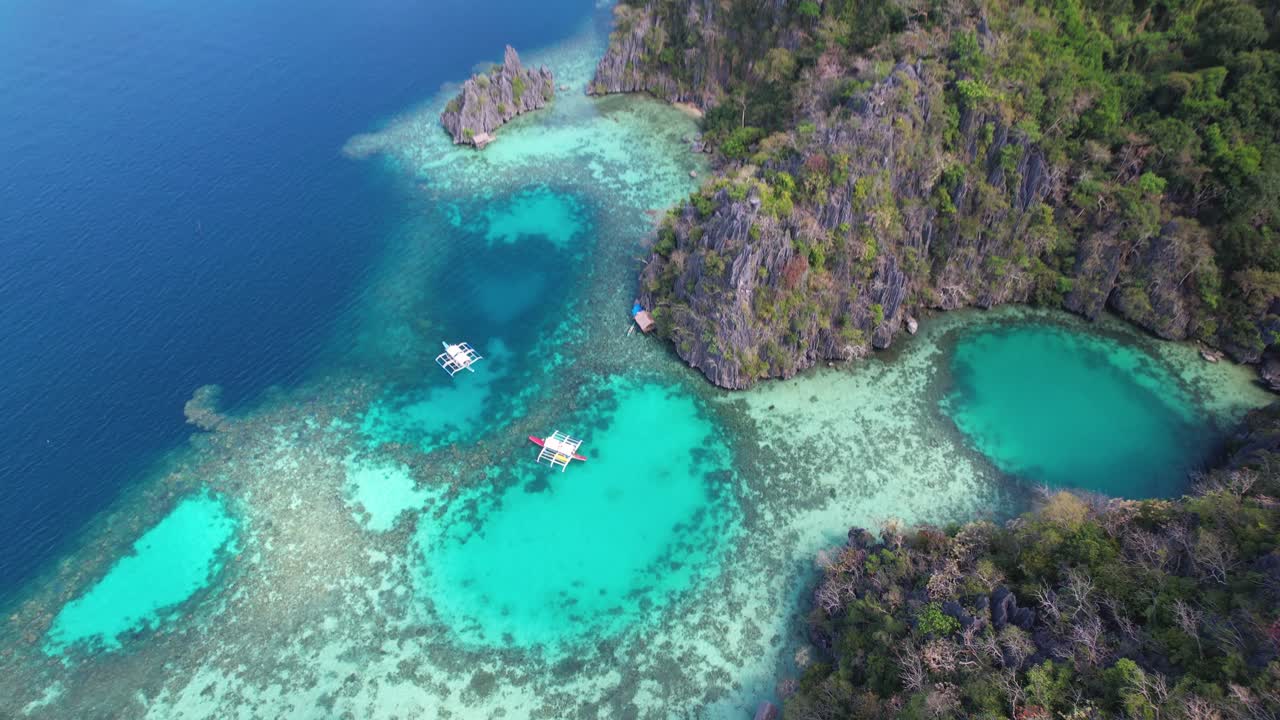 4K drone video of boats sailing around the tropical islands while on a boat tour from Coron in Palawan, Philippines