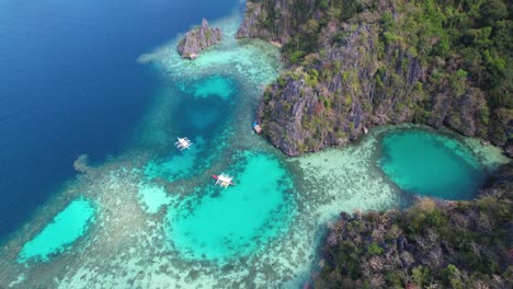 4k drone video of boats sailing around the tropical islands while on a boat tour from coron in palawan, philippines