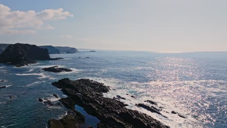 serene drone footage captures the beauty of the portuguese coastline, with its dramatic cliffs and the tranquil blue ocean stretching to the horizon