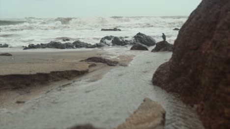 slow motion waves crashing into the shore and water flowing back into the sea