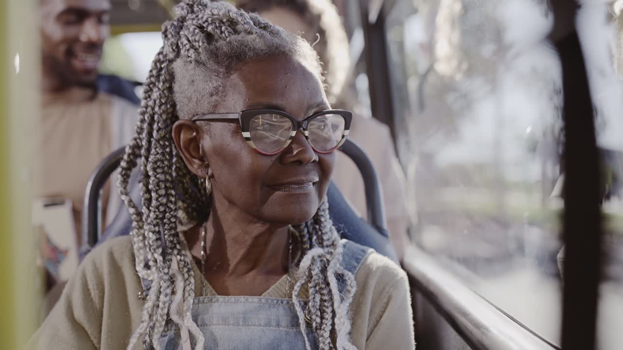 Elderly woman traveling by bus, looking out the window