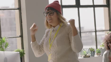 happy caucasian business woman celebrating success enjoying victory jumping excited colleagues clapping arms raised showing support cheerful enthusiastic teamwork in diverse office