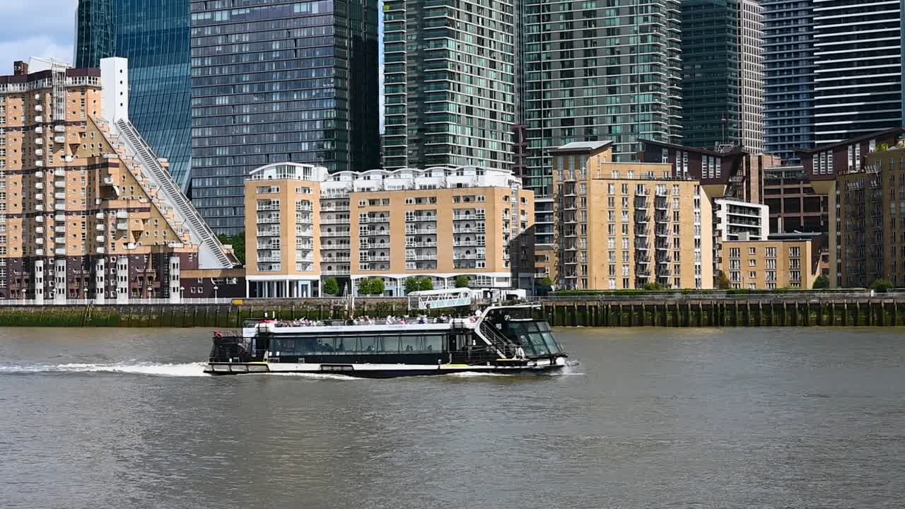 Avalon Waterways Suite Ship passing Canary Wharf, London, United Kingdom