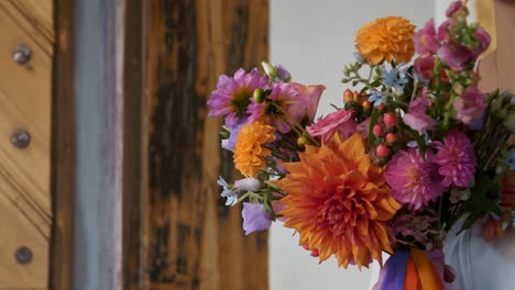 The-bride-holds-a-beautiful-colorful-wedding-bouquet-in-the-church