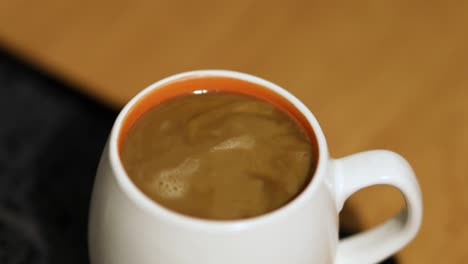 pouring milk into coffee cup