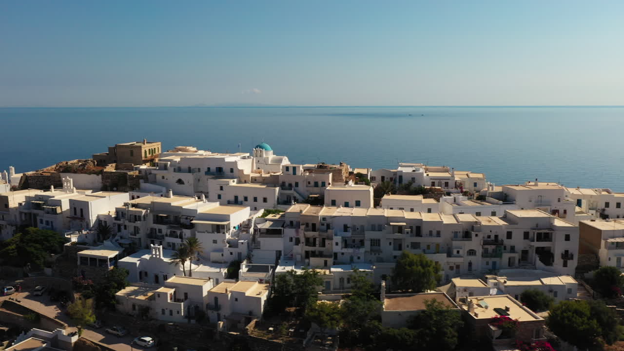 Aerial view of the traditional village of Kastro on the Greek island of Sifnos. 4K fly by ascending shot with the Aegean sea in the background.