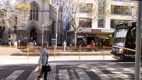 persona que cruza la calle cuando se acerca el tranvía