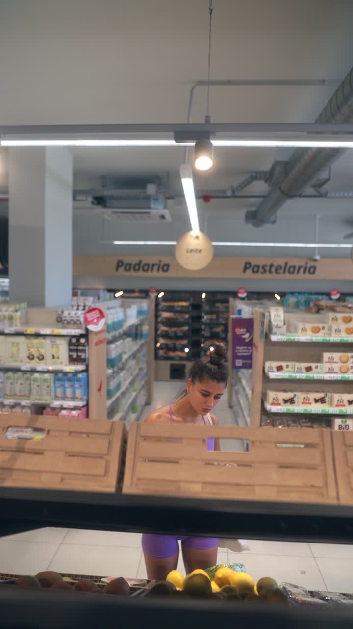 Woman shopping for produce in a supermarket