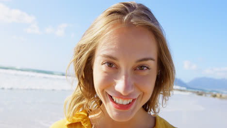 front view of young caucasian woman standing on the beach 4k