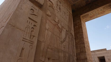 stunning hieroglyphs carved on walls at medinet habu, luxor, egypt