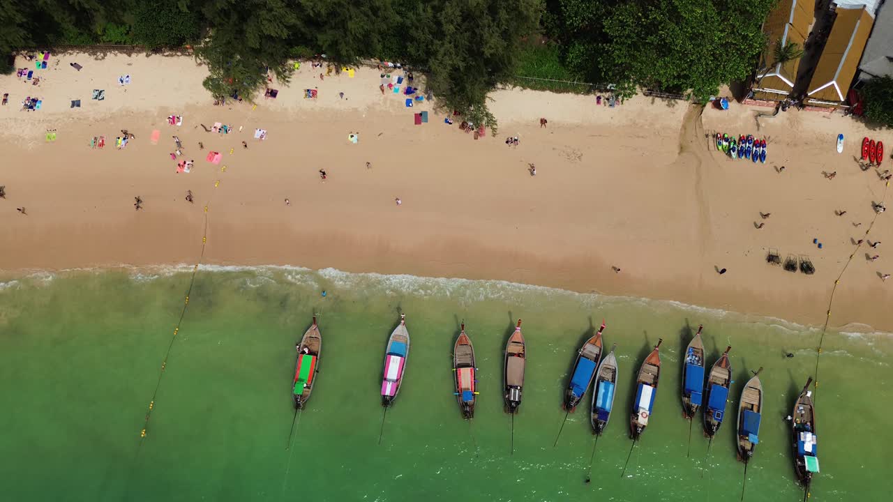 Traditional Thai longtail boats moored on Railay Beach Thailand, aerial drone view