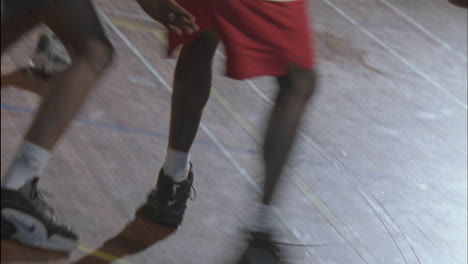 three men play basketball on an indoor court 5