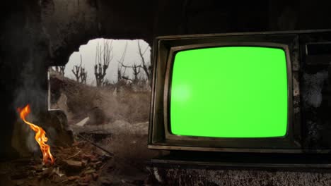 vintage tv set with green screen inside an old demolished building.