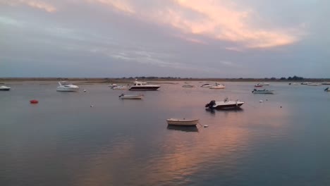 landscape of small boats in water at sunset