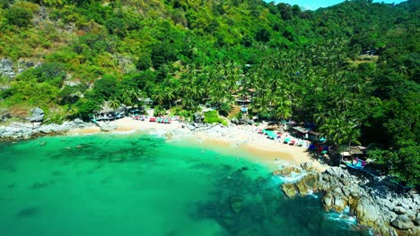 vibrant umbrellas line this hidden thai beach tucked between lush jungle hills and turquoise waters—an idyllic escape bursting with tropical charm.