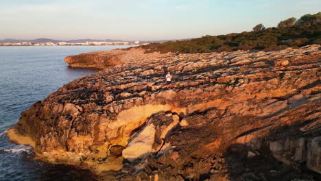 Sunlight-Illuminated-Rugged-Cliffs-Near-Sa-Coma-During-Sunrise-In-Mallorca-Spain