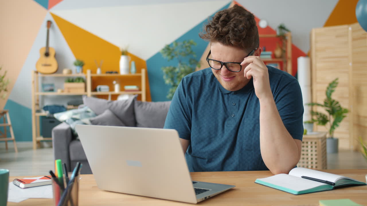 Man looking confused at laptop