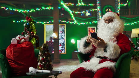 santa claus using a smartphone during christmas