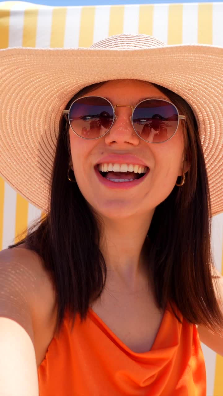 Woman with hat and sunglasses on the beach | Premium Stock Video Footage