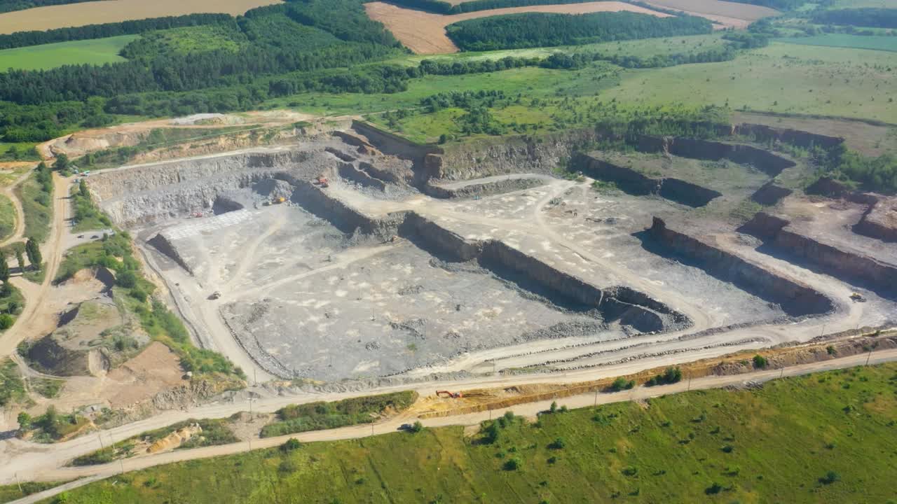Granite quarry. Extraction of granite. Open cast mine. Mining industry. Stone Quarrying - Aerial view