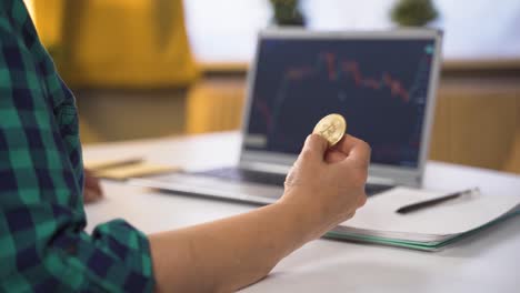 investor examining cryptocurrency chart. she has bitcoin.