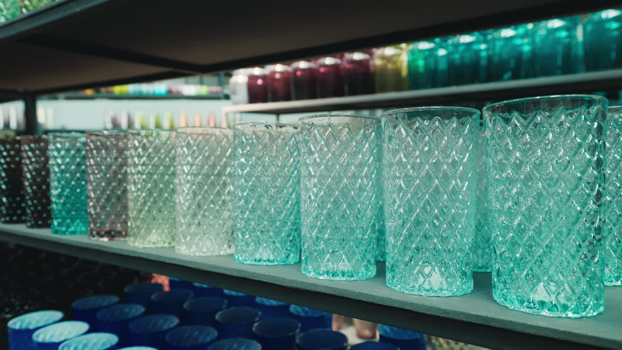 Assortment of colorful patterned glass tumblers on store shelves