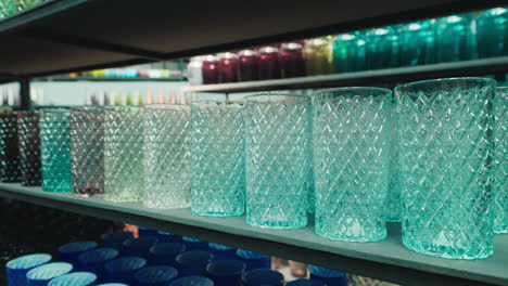 Assortment of colorful patterned glass tumblers on store shelves