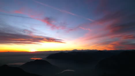 pink orange colored sunset over resegone mountain range in northern italy