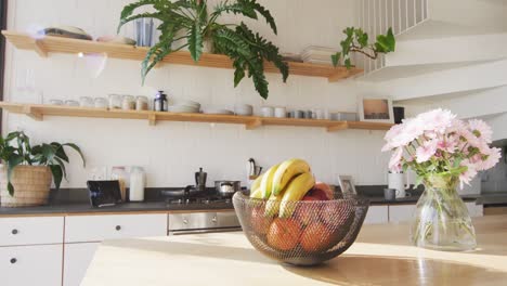 general view of modern kitchen with countertop, kitchen equipment and fruits