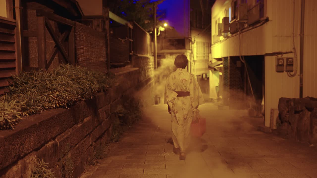 Japanese Woman Walks Through Beppu, Steam from Geothermal Ryokan at Night