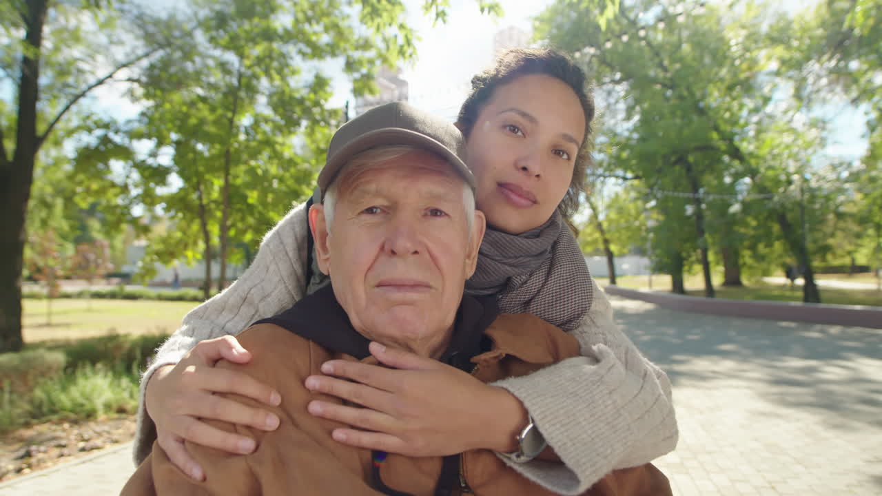Senior man with caregiver in the park