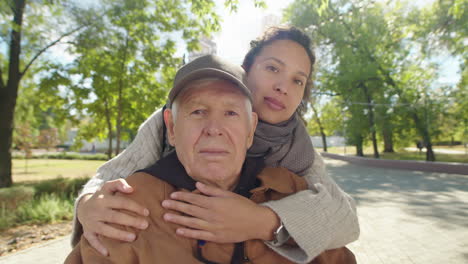 senior man with caregiver in the park