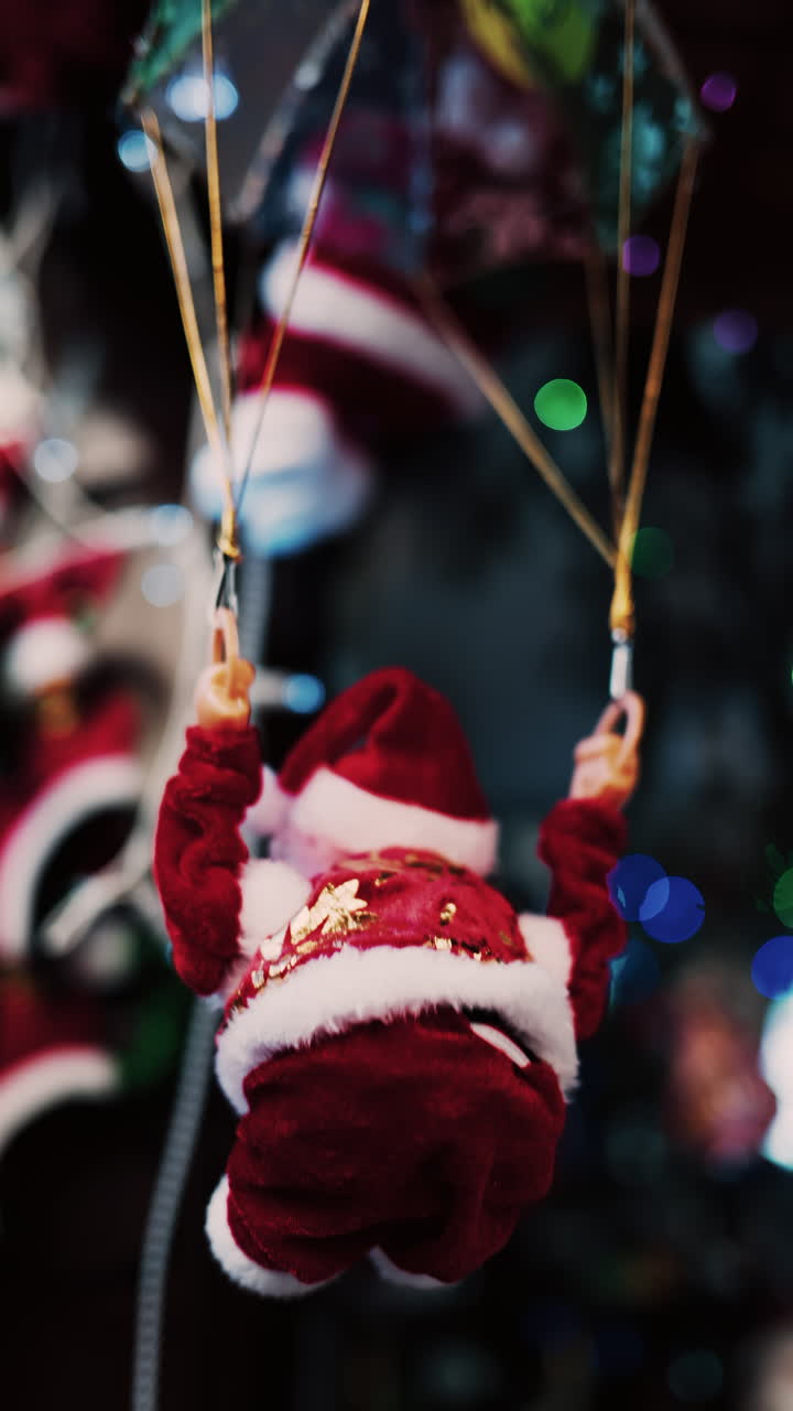 Santa Claus toy rotating back and forth with a blurry background. Vertical