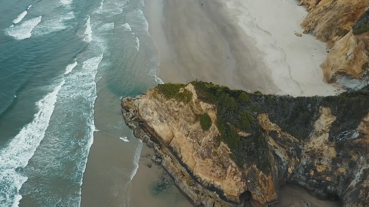4k aerial drone pan down over rock outcropping on the Oregon coast