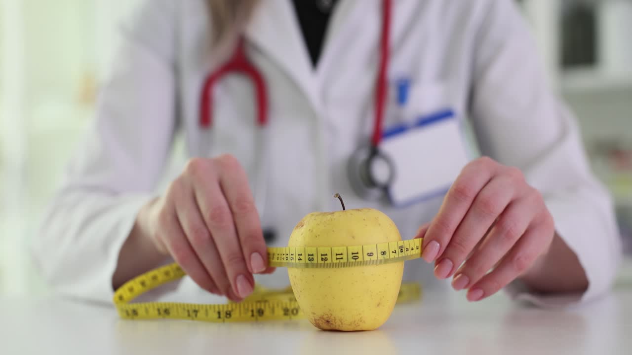 Doctor measuring an apple