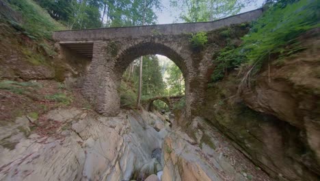 Roncobello-Valle-Brembana-Italy,-the-new-bridge-and-then-the-old-Roman-bridge-destroyed-in-2023-by-bad-weather